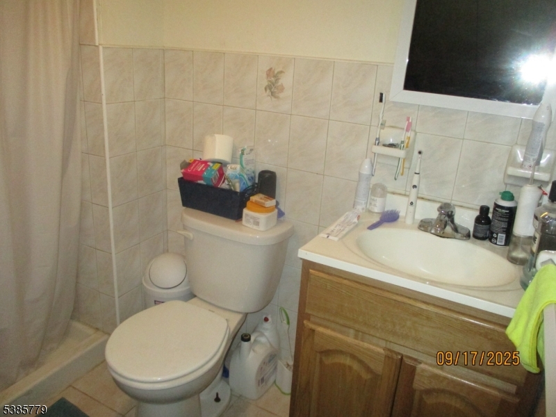 7 Kossuth Street Newark, NJ 07105 - Photo 17 of 18 a bathroom with a sink a toilet and a mirror