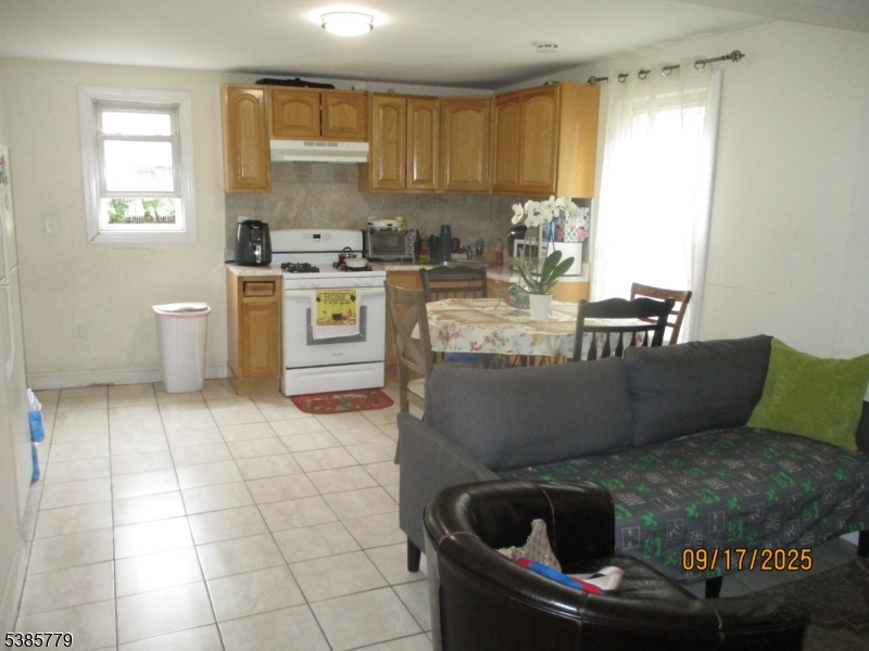 7 Kossuth Street Newark, NJ 07105 - Photo 3 of 18 a kitchen with a stove a sink a counter space and a window