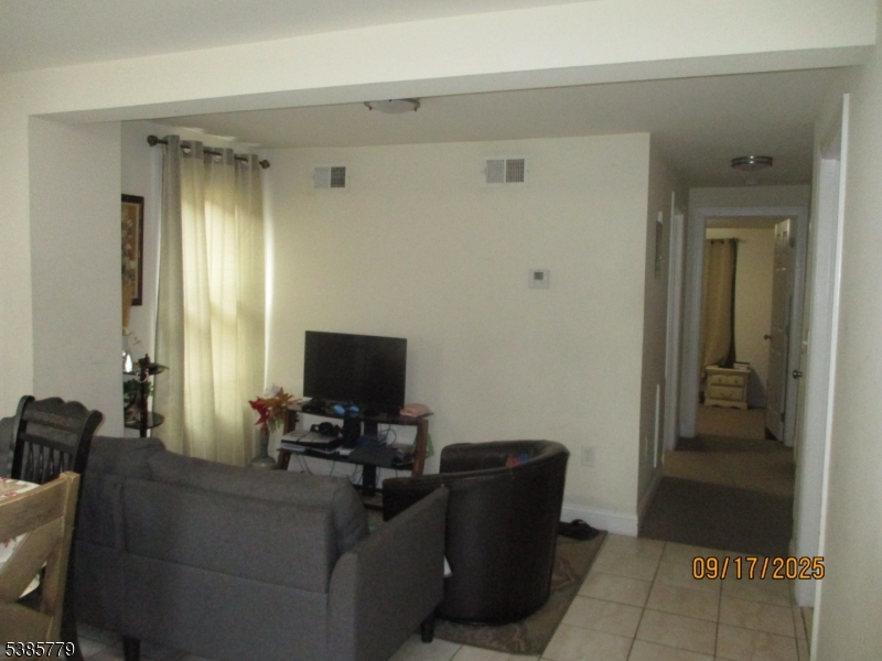 7 Kossuth Street Newark, NJ 07105 - Photo 4 of 18 a living room with furniture and a flat screen tv