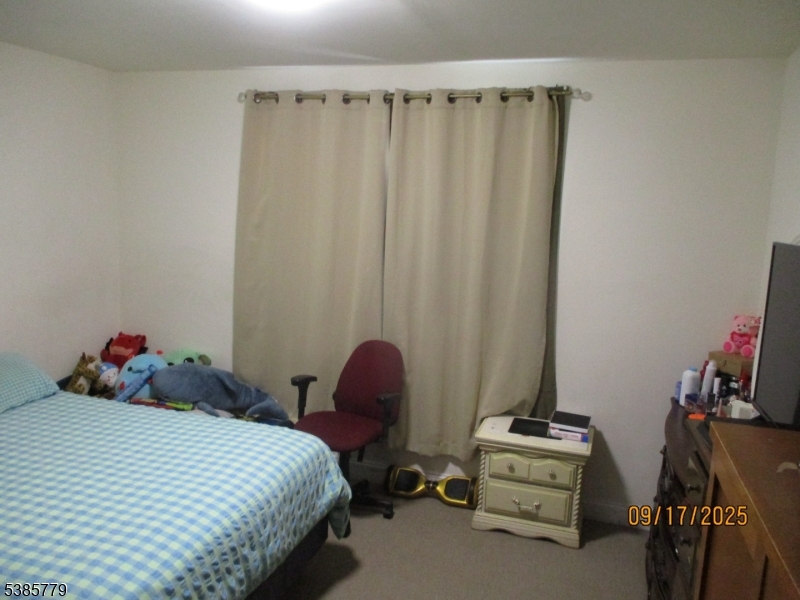 7 Kossuth Street Newark, NJ 07105 - Photo 5 of 18 a bedroom with bed and a window