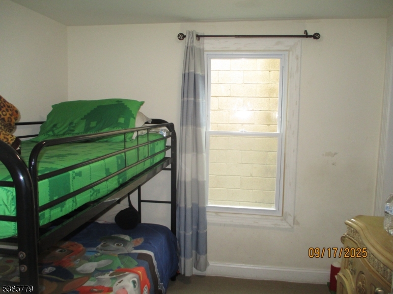 7 Kossuth Street Newark, NJ 07105 - Photo 6 of 18 a bedroom with a bed and a window
