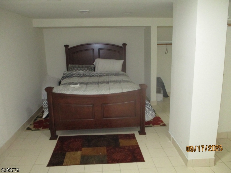 7 Kossuth Street Newark, NJ 07105 - Photo 8 of 18 a room with a bench and a rug