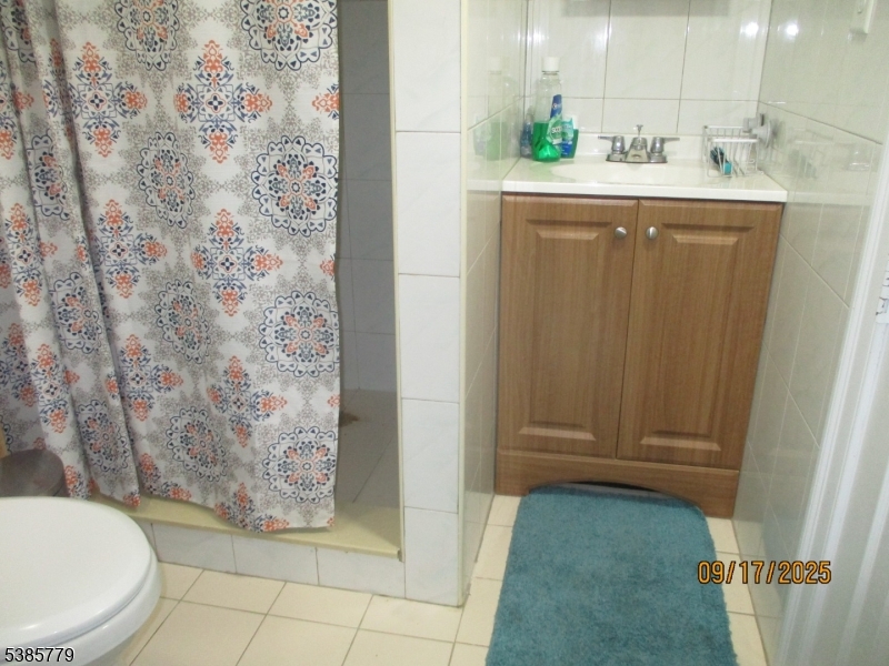 7 Kossuth Street Newark, NJ 07105 - Photo 9 of 18 a bathroom with a sink a toilet and shower