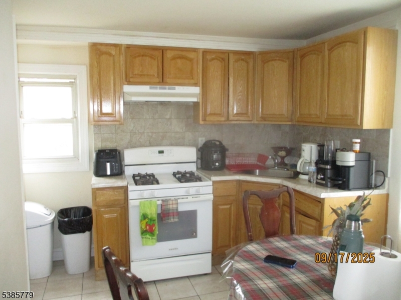 7 Kossuth Street Newark, NJ 07105 - Photo 10 of 18 a kitchen with a sink a stove and cabinets