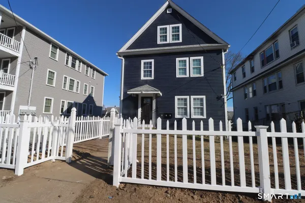 a front view of a house with a fence