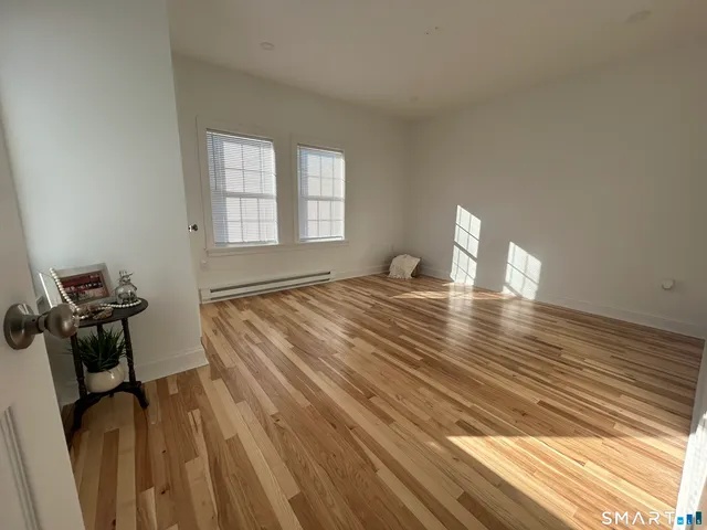 a view of a room with wooden floor