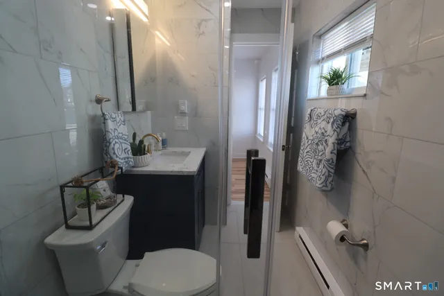 a bathroom with a toilet sink and shower