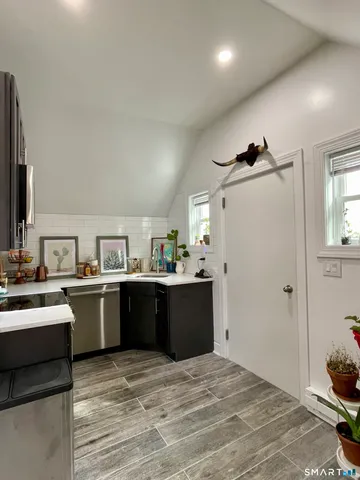 a large kitchen with kitchen island a sink stainless steel appliances and cabinets