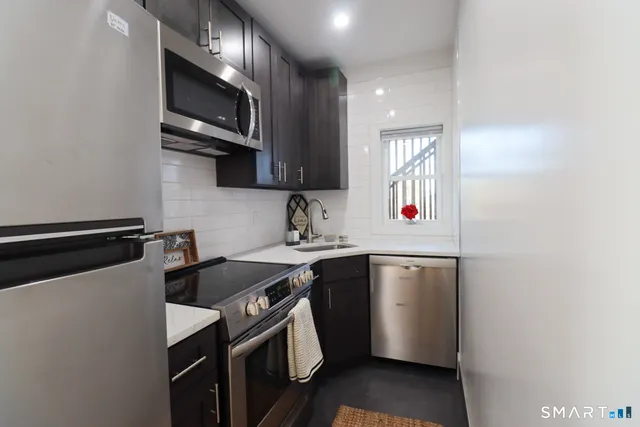 a kitchen with stainless steel appliances a sink stove and microwave