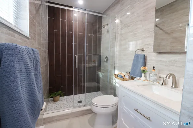 a bathroom with a sink toilet and shower