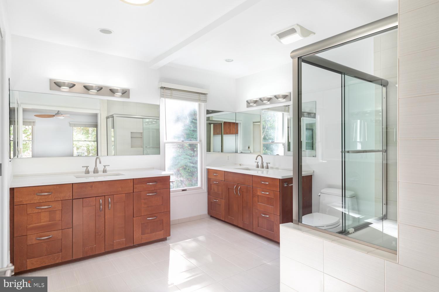 11603 Deer Forest Road Reston, VA 20194 - Photo 18 of 38 a spacious bathroom with a granite countertop tub sink and mirror
