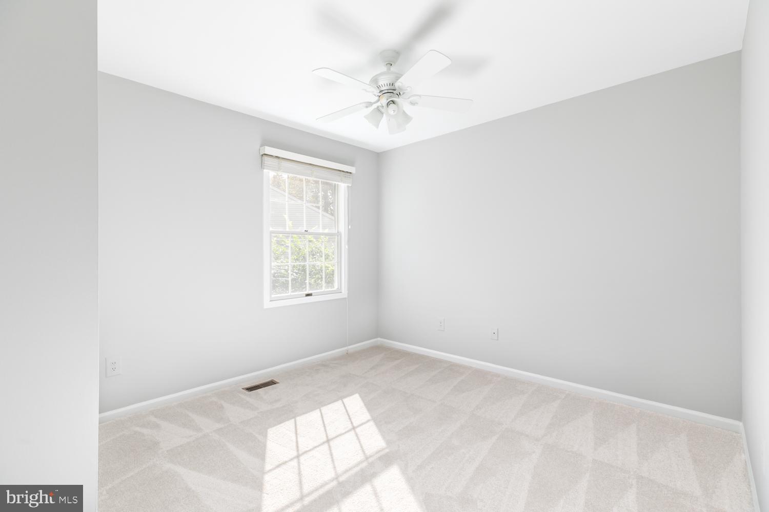 11603 Deer Forest Road Reston, VA 20194 - Photo 22 of 38 an empty room with a window and a ceiling fan