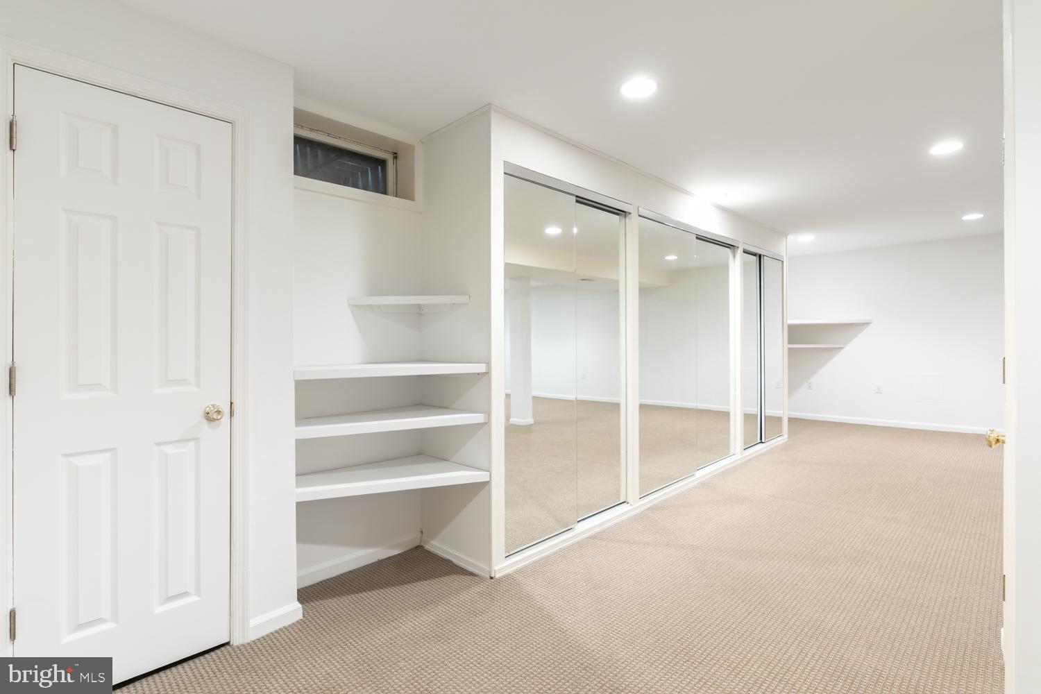 11603 Deer Forest Road Reston, VA 20194 - Photo 29 of 38 a view of an empty room with a cabinet and mirrors