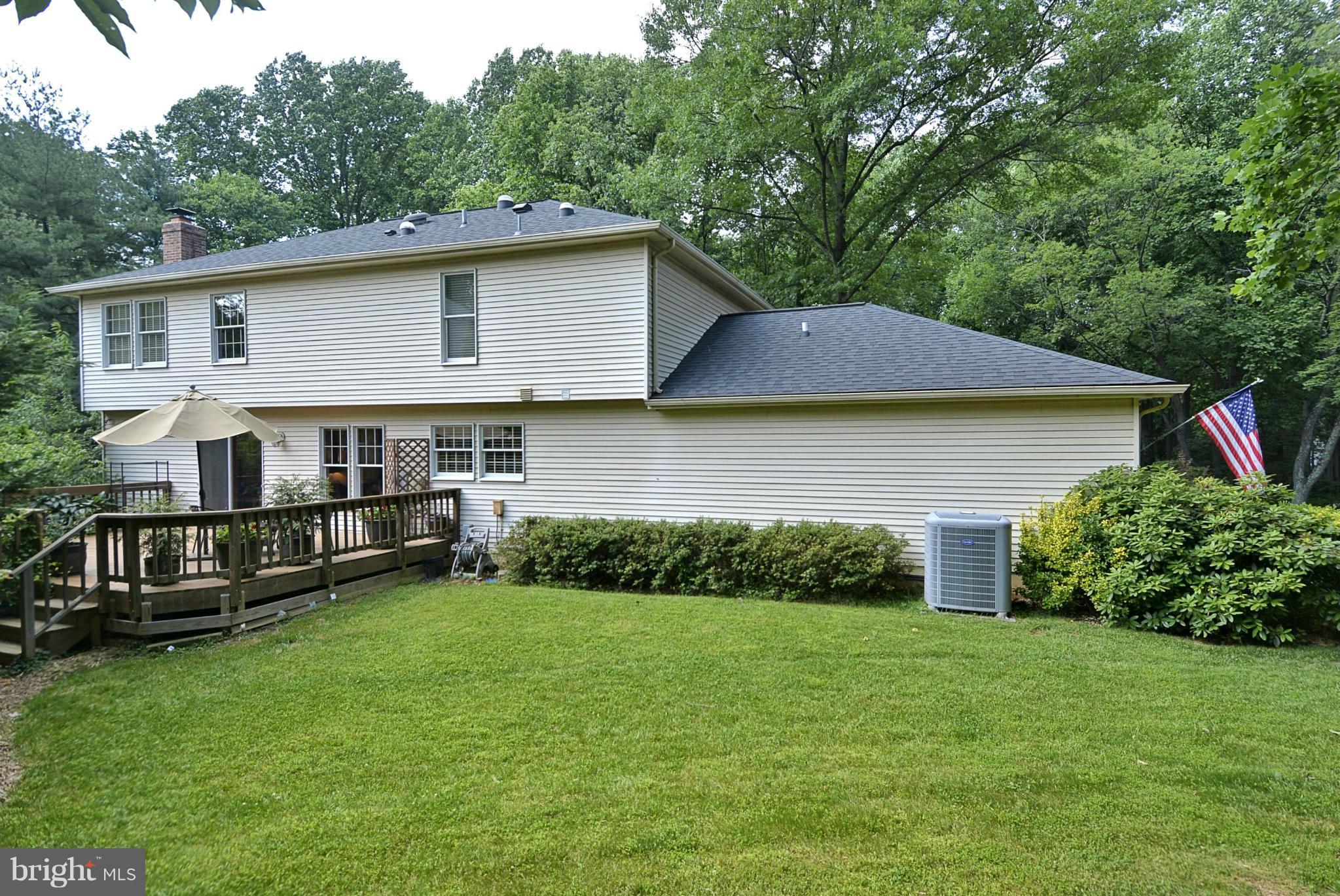 11603 Deer Forest Road Reston, VA 20194 - Photo 33 of 38 a view of a house with a yard chairs and a table under an umbrella