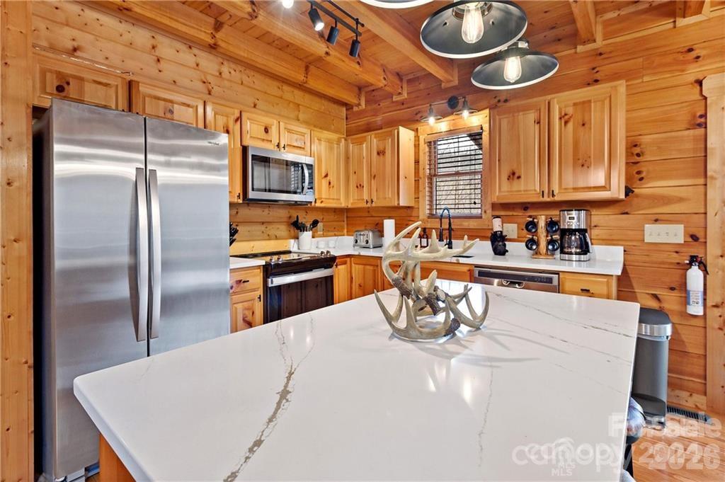 552 Lake Road Old Fort, NC 28762 - Photo 11 of 46 a kitchen with stainless steel appliances granite countertop a sink a stove and a refrigerator