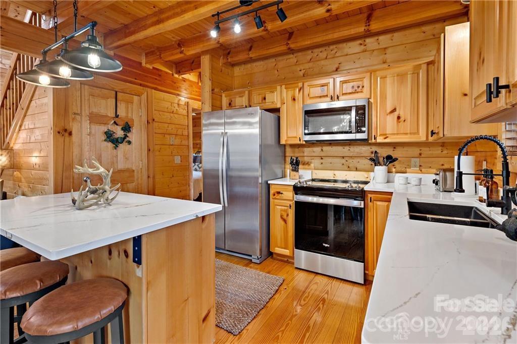 552 Lake Road Old Fort, NC 28762 - Photo 12 of 46 a kitchen with stainless steel appliances a stove a sink a microwave and refrigerator