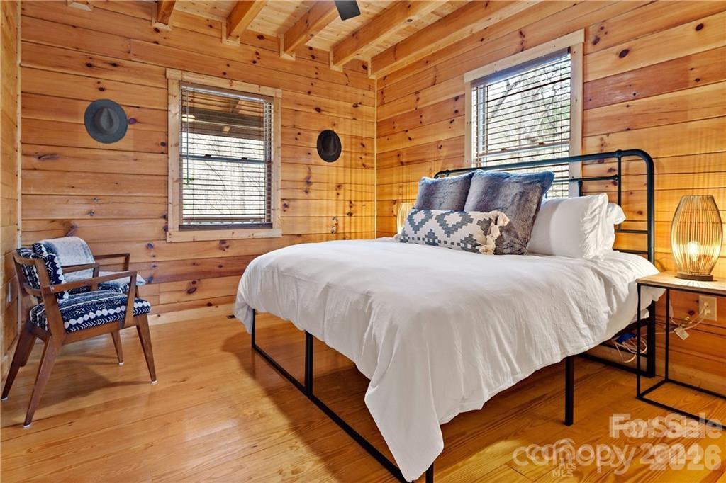 552 Lake Road Old Fort, NC 28762 - Photo 15 of 46 a bedroom with a bed and chair