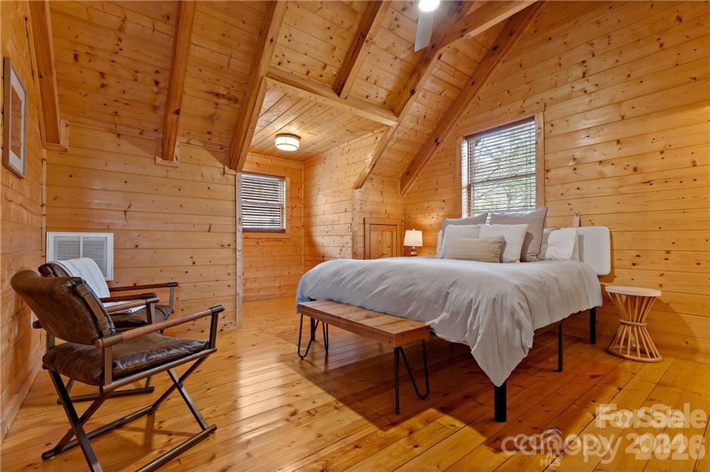 552 Lake Road Old Fort, NC 28762 - Photo 24 of 46 a bedroom with a bed and wooden floor