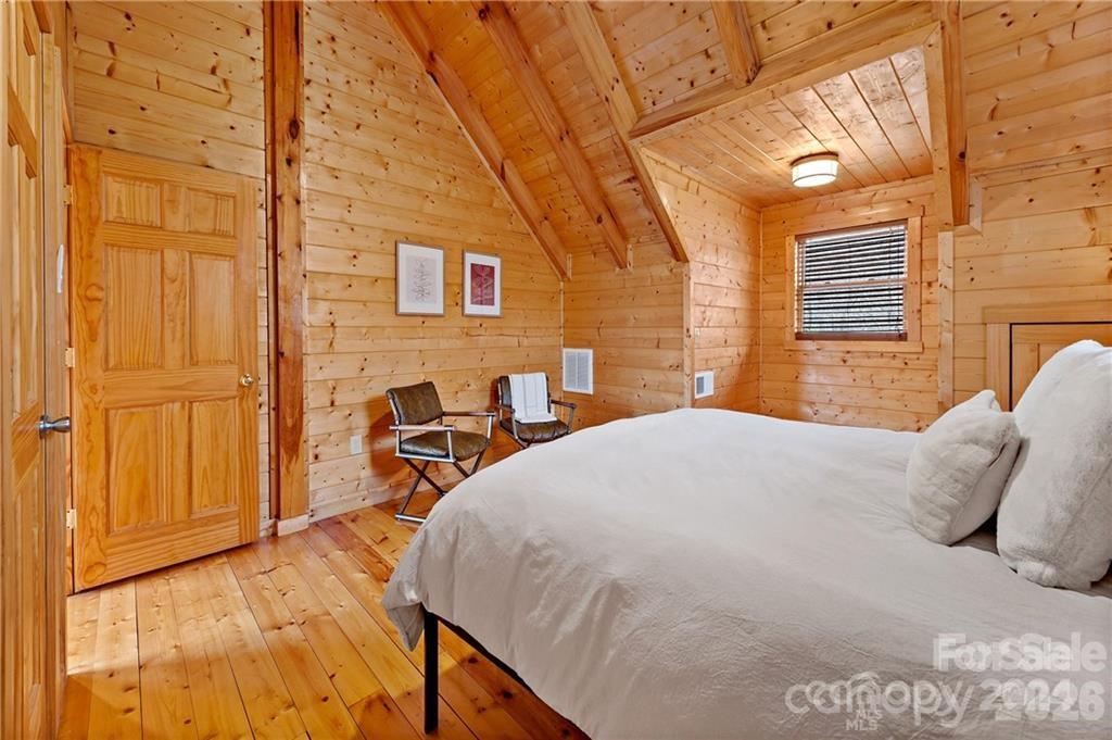 552 Lake Road Old Fort, NC 28762 - Photo 25 of 46 a bedroom with a bed and wooden floor