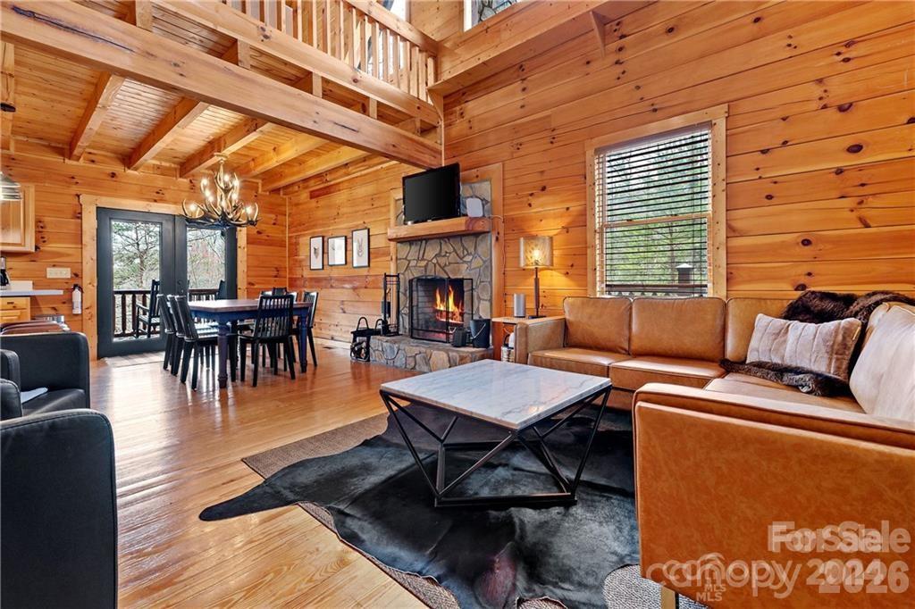 552 Lake Road Old Fort, NC 28762 - Photo 8 of 46 a dining room with furniture fireplace and a floor to ceiling window