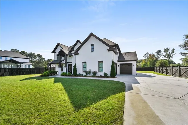a front view of house with yard and green space