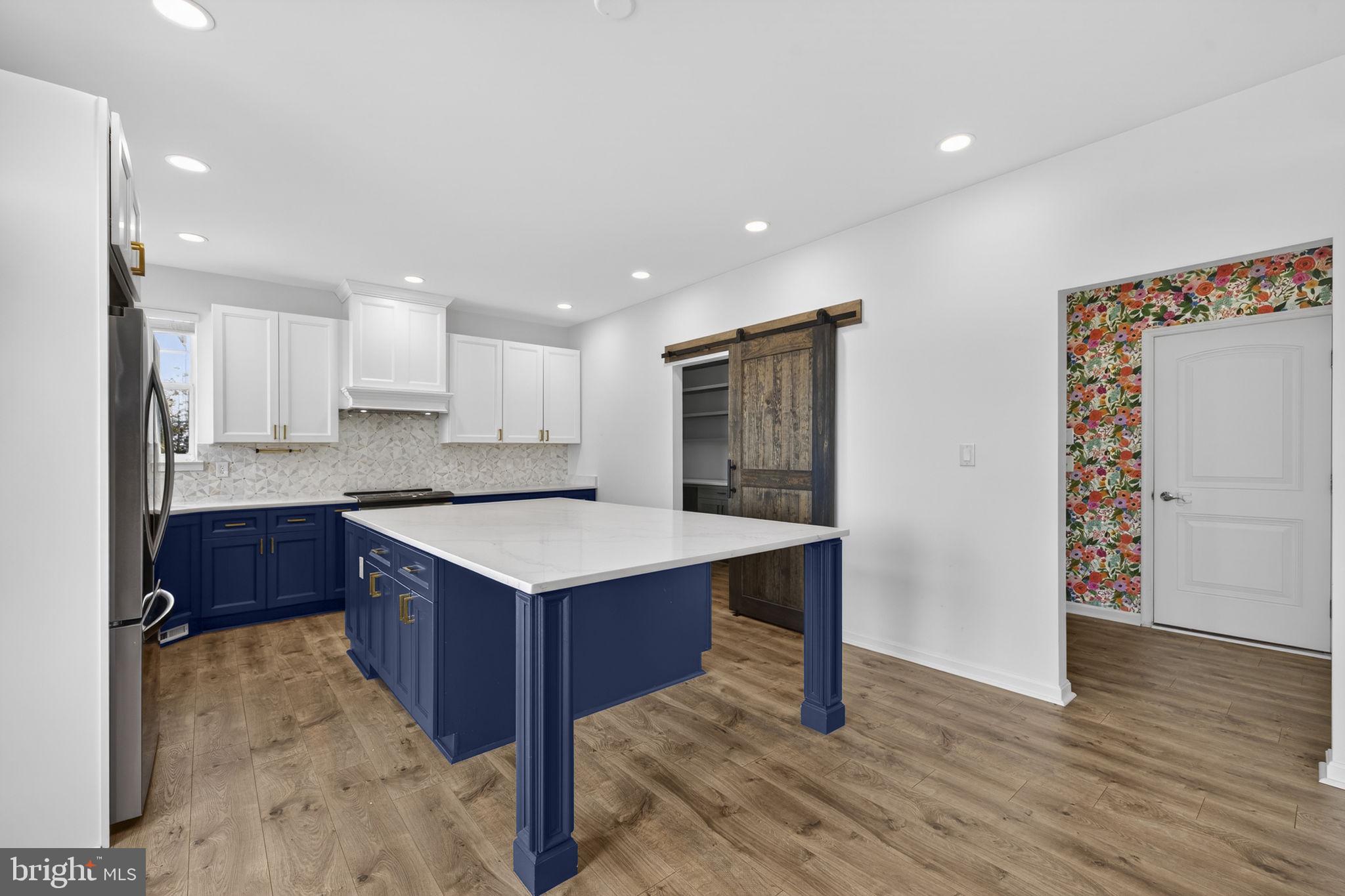 43132 Butterfly Way Leesburg, VA 20176 - Photo 12 of 63 a kitchen with a sink a refrigerator and wooden floor