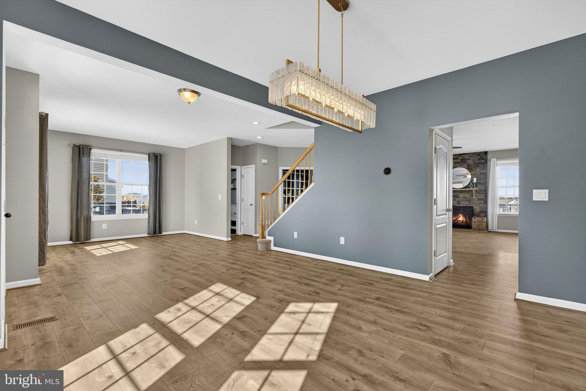 43132 Butterfly Way Leesburg, VA 20176 - Photo 19 of 63 a view of an empty room with wooden floor and a chandelier