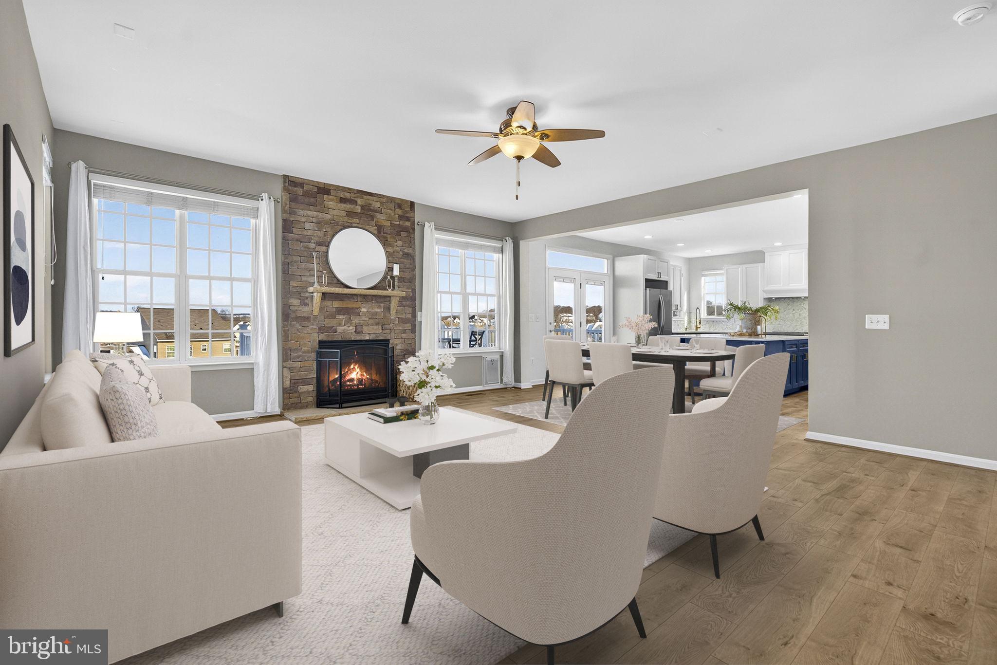 43132 Butterfly Way Leesburg, VA 20176 - Photo 23 of 63 a living room with furniture a fireplace and a chandelier