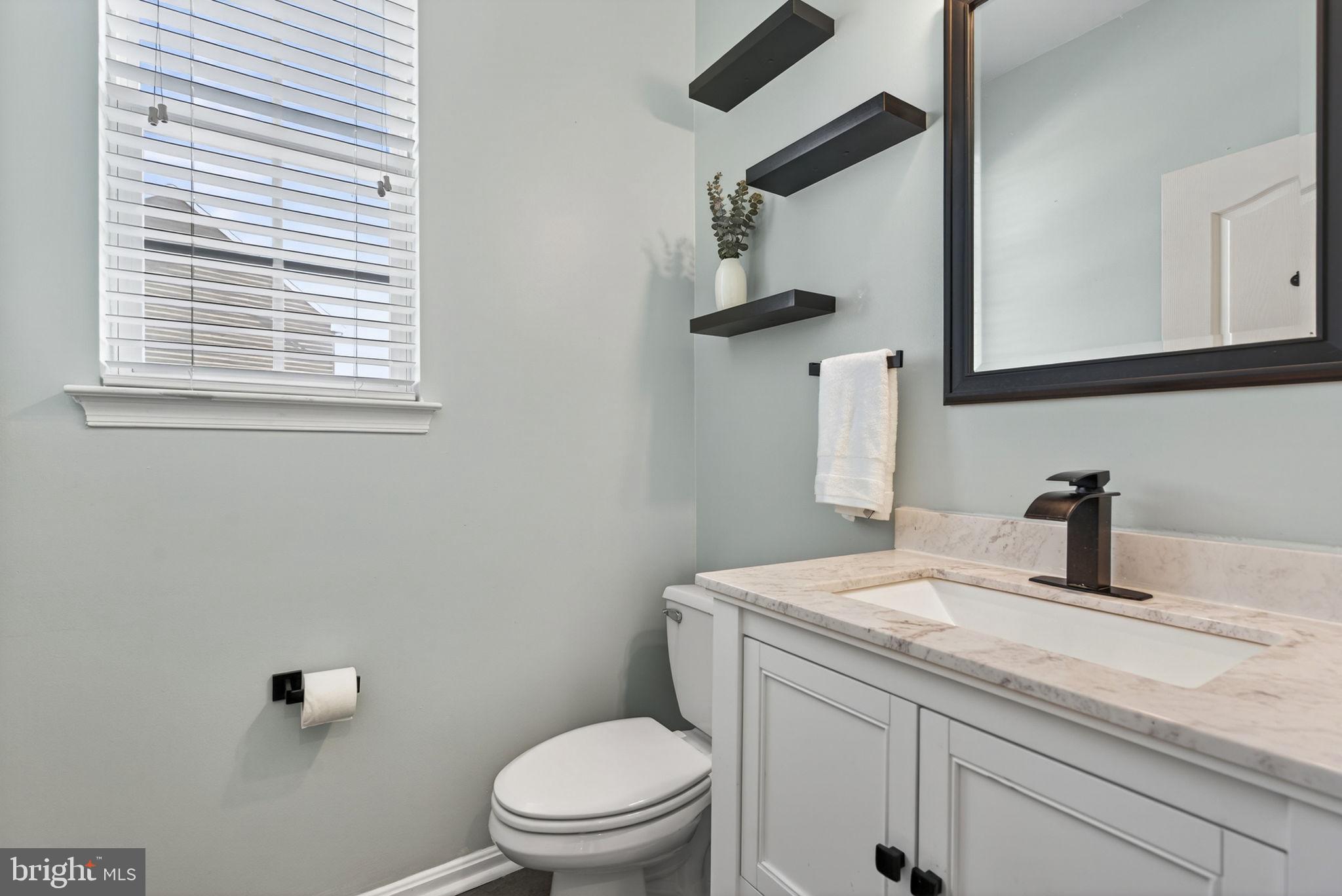 43132 Butterfly Way Leesburg, VA 20176 - Photo 27 of 63 a bathroom with a granite countertop sink toilet and mirror