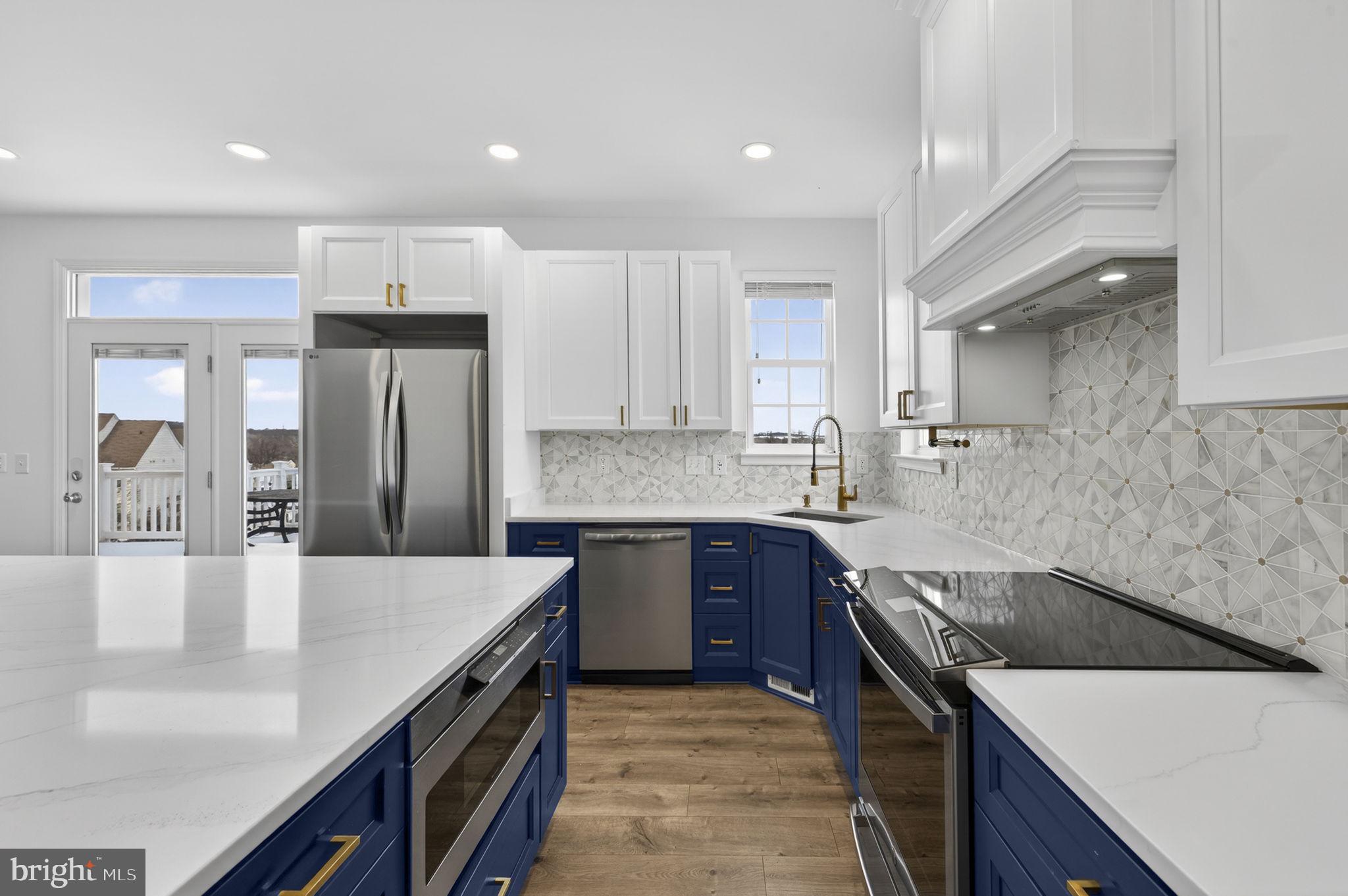 43132 Butterfly Way Leesburg, VA 20176 - Photo 8 of 63 a kitchen with stainless steel appliances granite countertop a sink a stove and a refrigerator