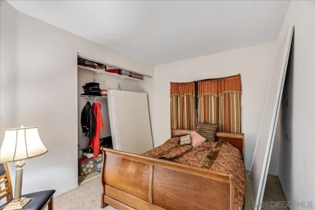 a bedroom with a bed and a lamp on table