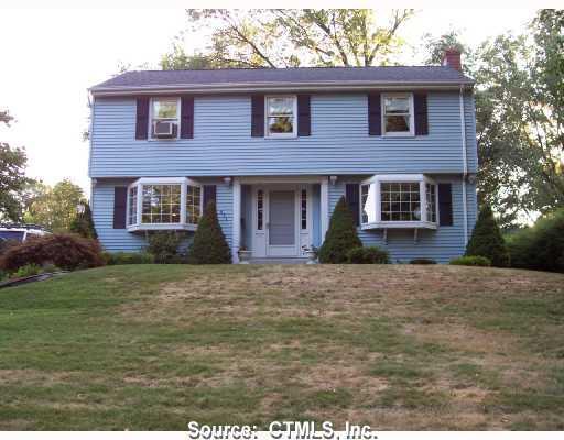 471 Ridge Road Wethersfield, CT 06109 - Photo 1 of 1 a front view of a house with a garden