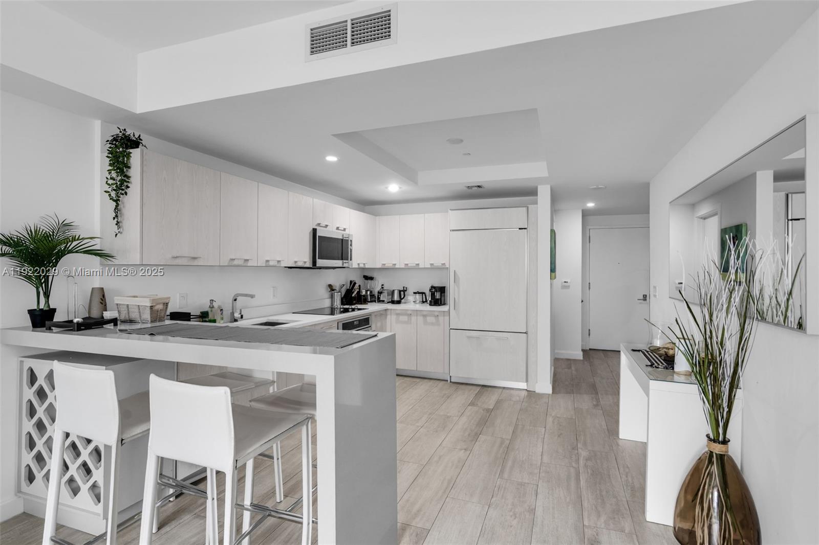 55 Southwest 9th Street, Unit 1705 Miami, FL 33130 - Photo 7 of 28 a kitchen with stainless steel appliances granite countertop a refrigerator and a stove top oven
