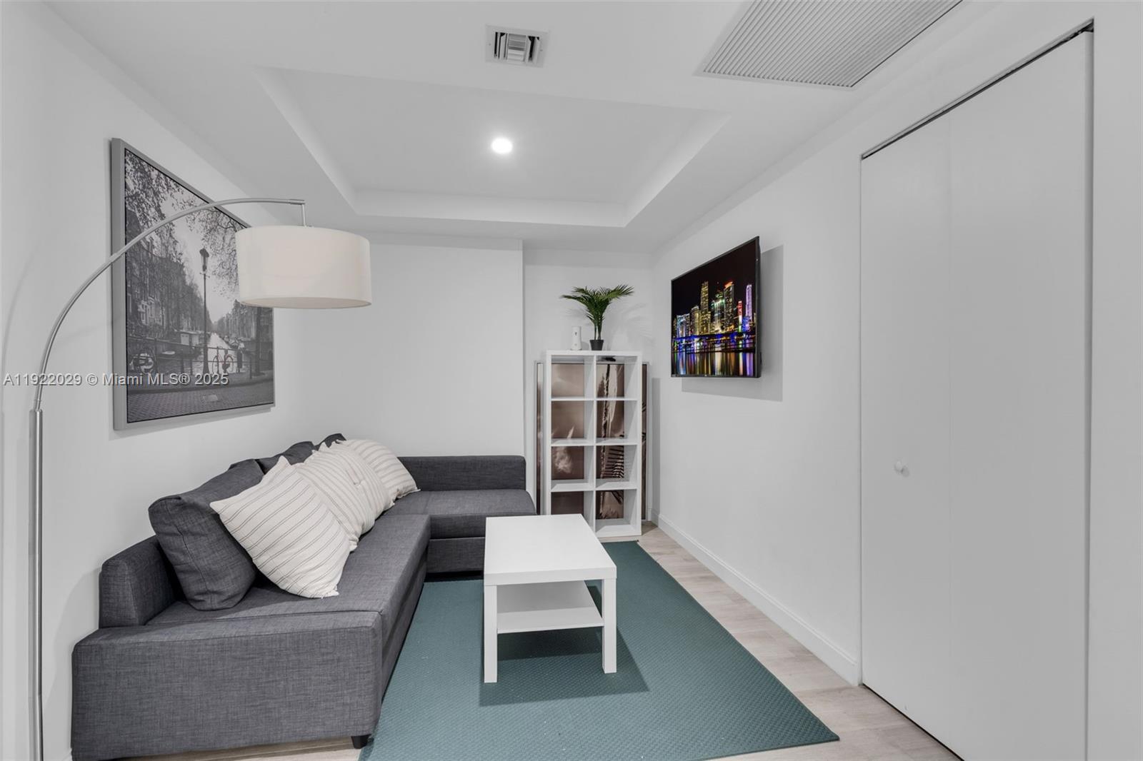 55 Southwest 9th Street, Unit 1705 Miami, FL 33130 - Photo 9 of 28 a living room with furniture and a rug