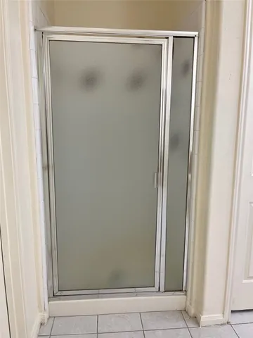 a bathroom with a glass shower door