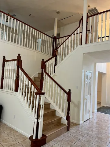 a view of staircase with railing and a floor to ceiling window