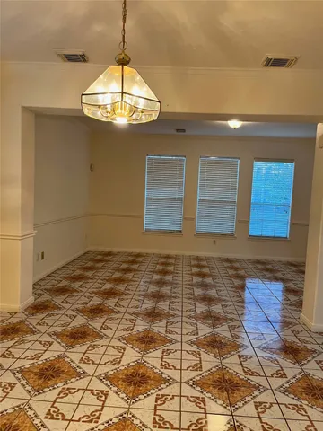 a view of a hallway with chandelier