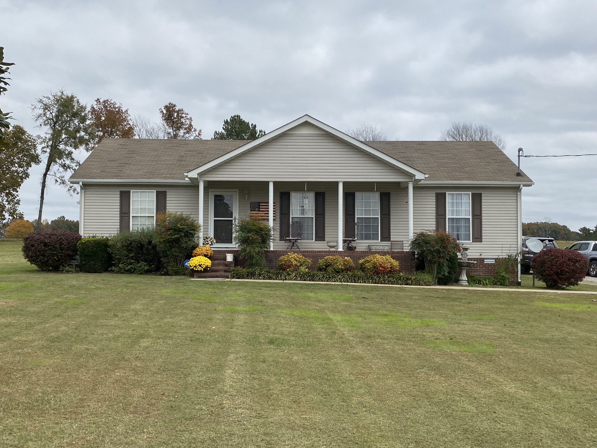 a view of a house with a yard and potted plants