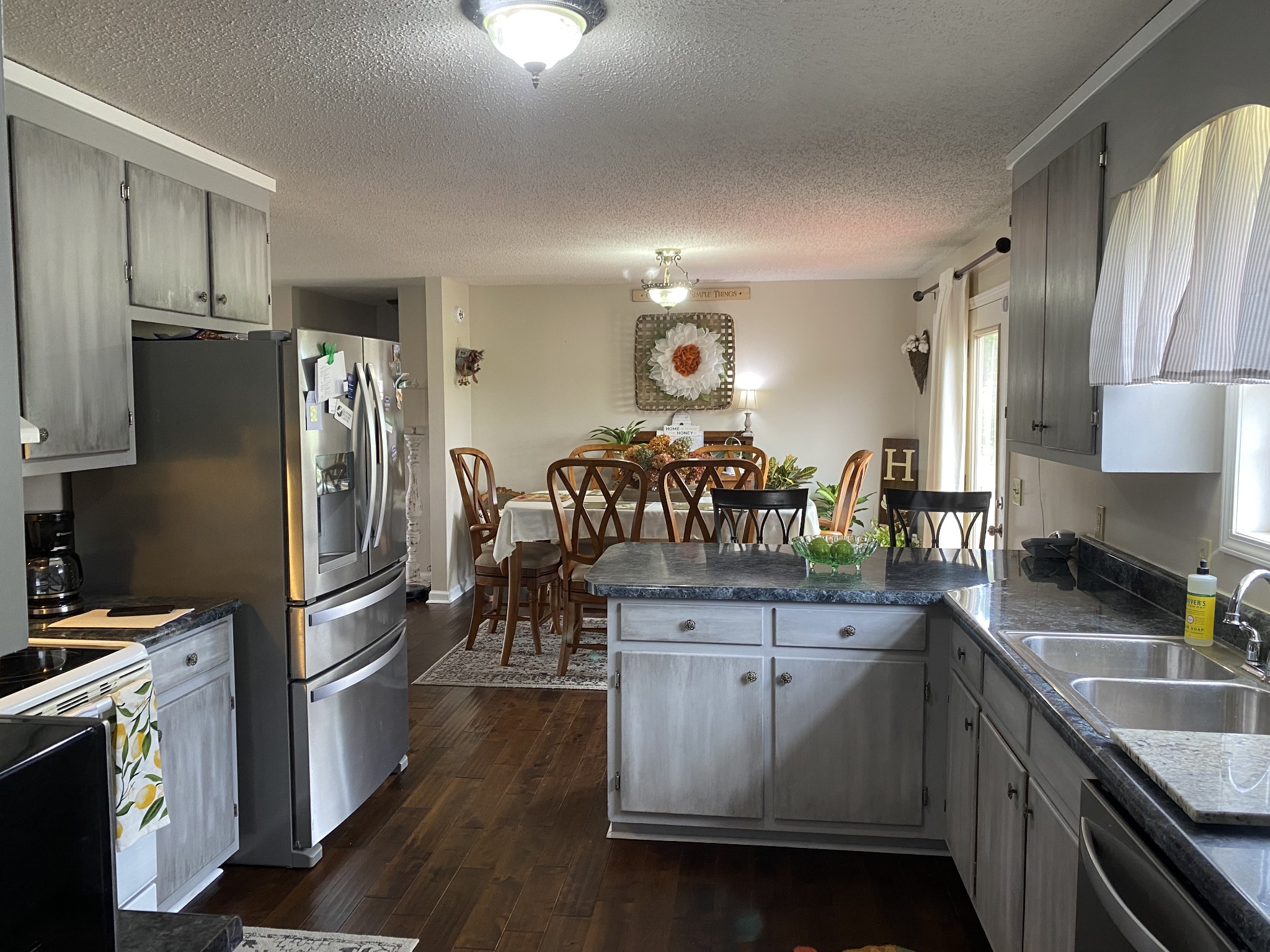 876 Barnette Road Minor Hill, TN 38473 - Photo 8 of 27 a kitchen with stainless steel appliances a sink stove refrigerator and cabinets