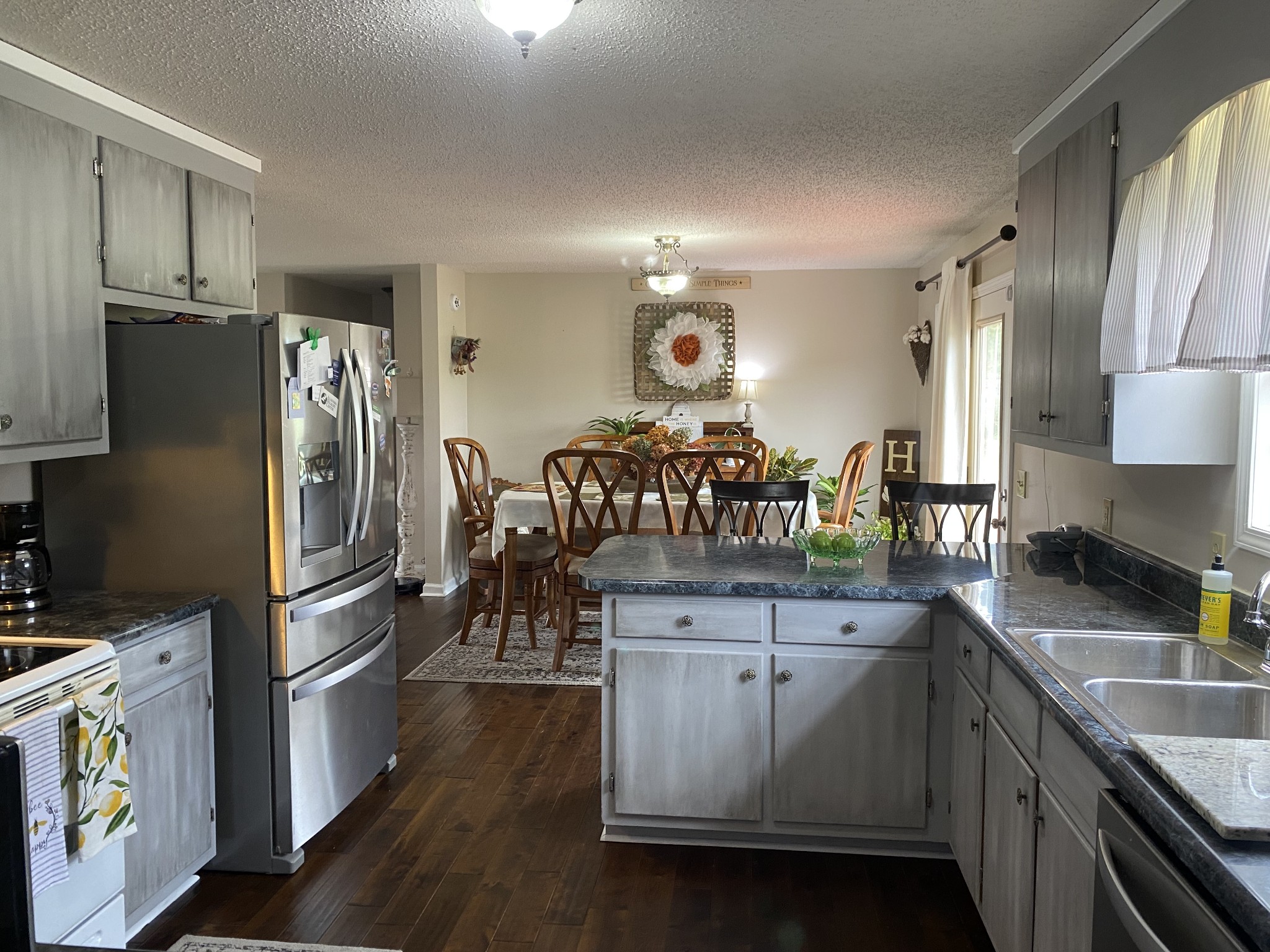 876 Barnette Road Minor Hill, TN 38473 - Photo 9 of 27 a kitchen with stainless steel appliances granite countertop a refrigerator a stove a sink and a microwave