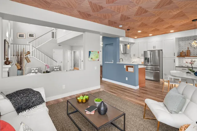 a living room with furniture and painting on the wall