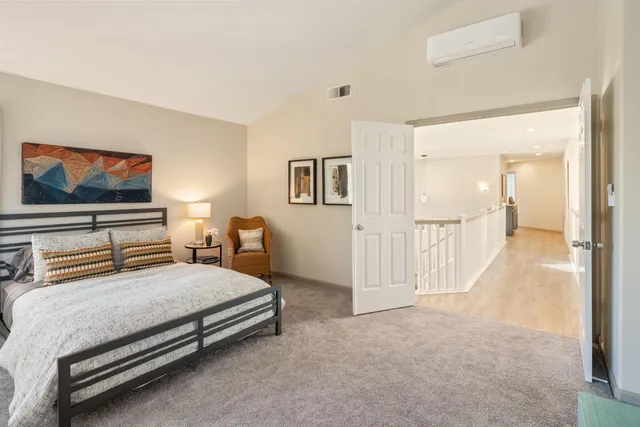 a bedroom with a bed and a desk