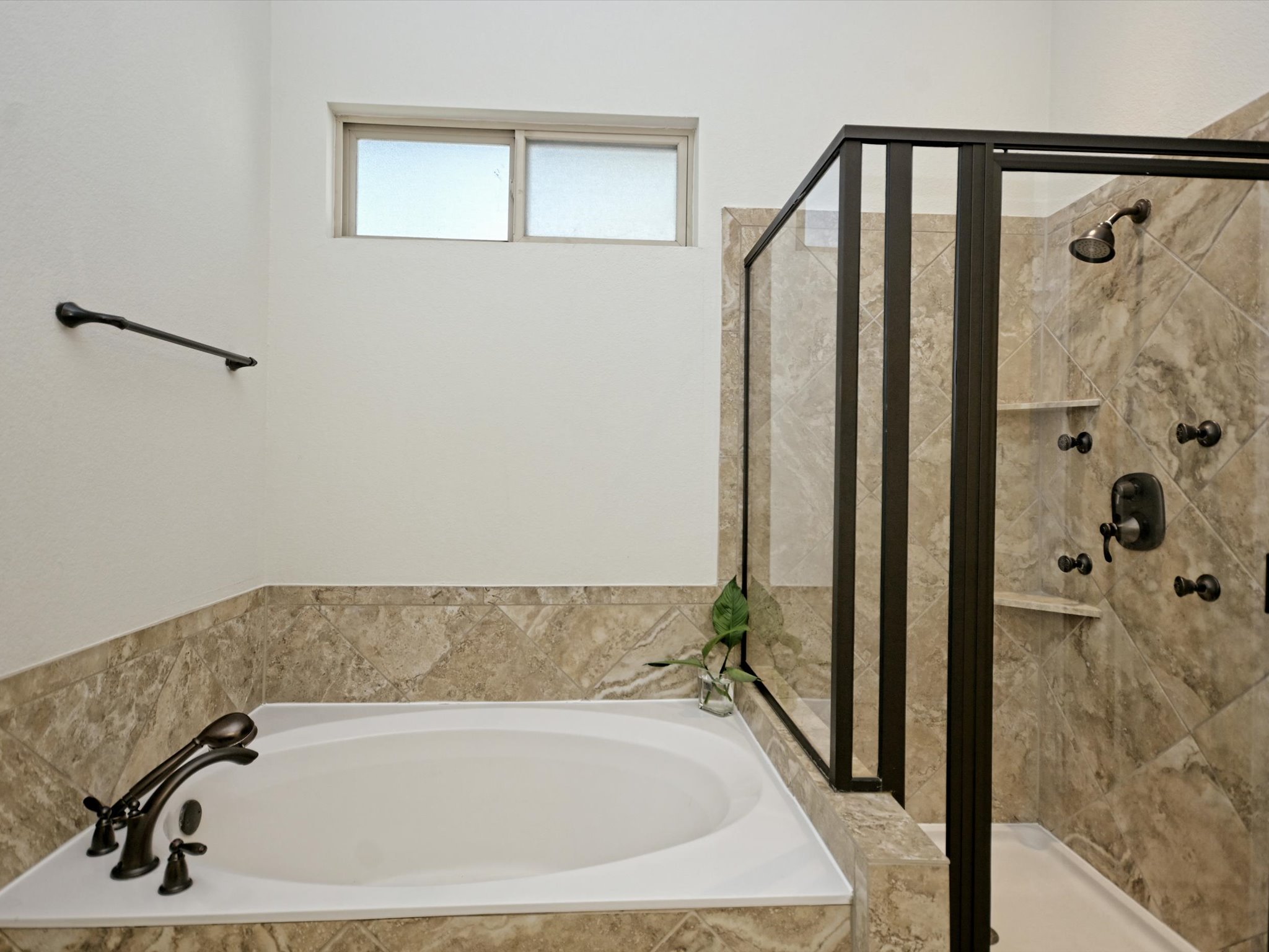 201 Bellagio Drive Austin, TX 78734 - Photo 17 of 31 Soak off the day;s stress in the relaxing tub and enjoy a large walk-in shower with modern glass enclosure and tile surround.