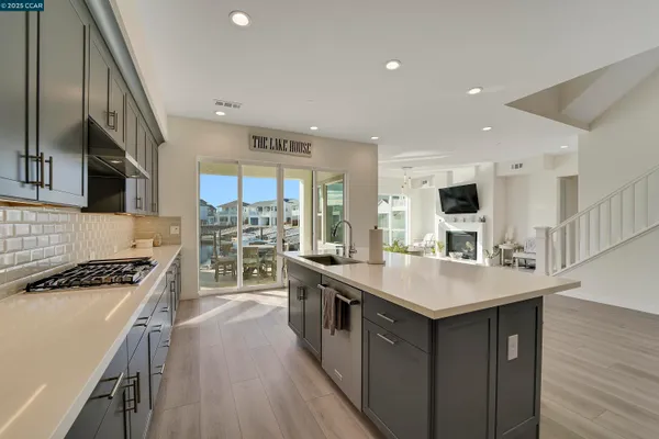a kitchen with a sink a refrigerator and wooden cabinets