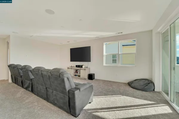 a living room with furniture ceiling fan and a rug