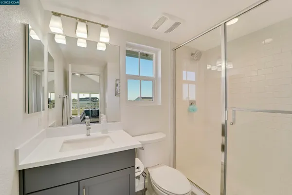 a bedroom with a bed and glass door