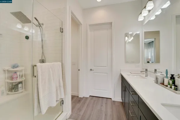 a view of a large white kitchen with a large window