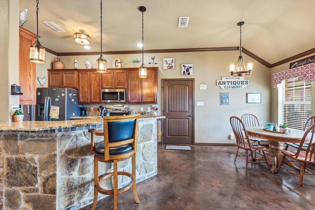 171 Ridge Top Drive Decatur, TX 76234 - Photo 12 of 40 a kitchen with refrigerator and chairs