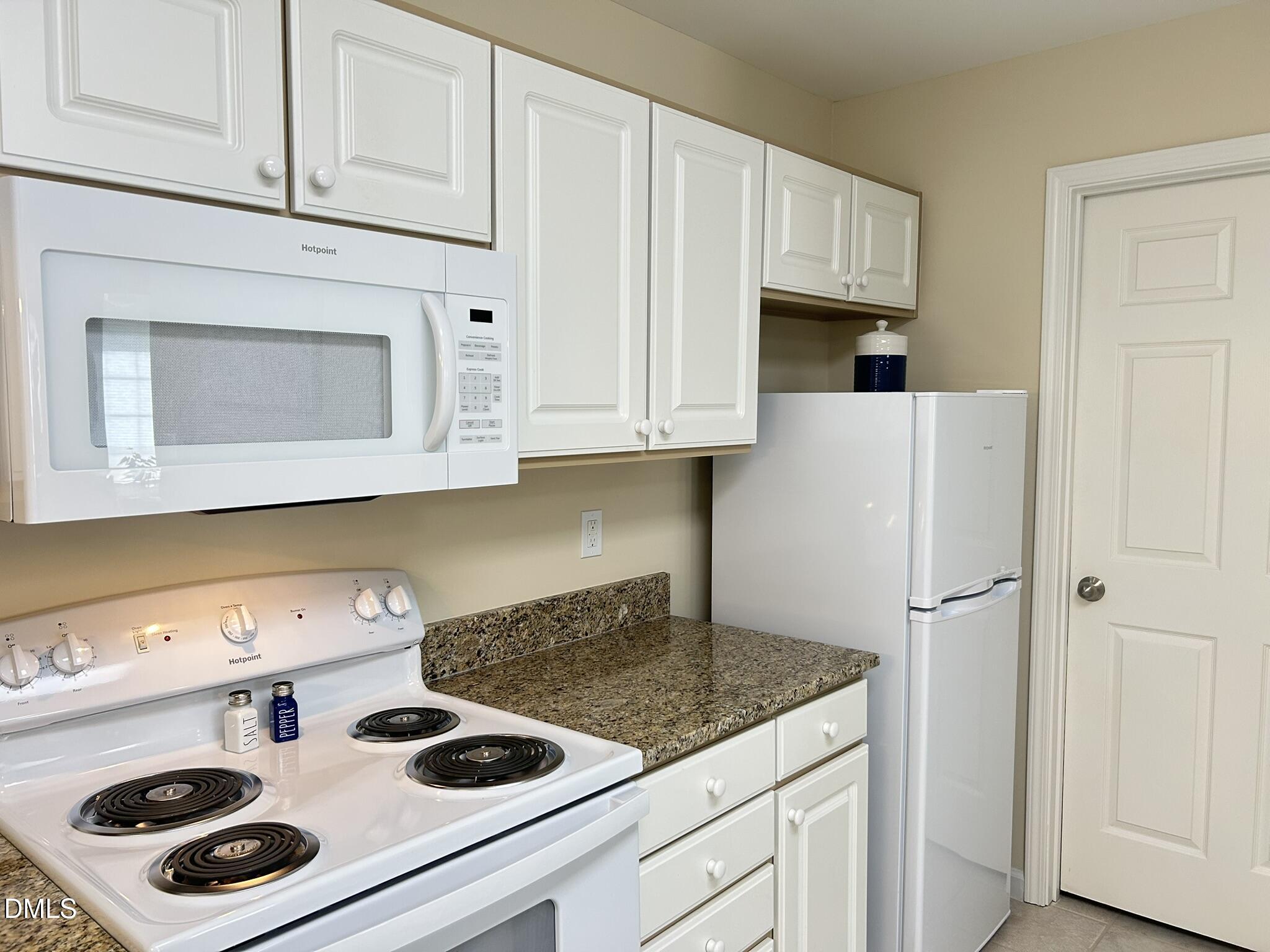 2510 Friedland Place, Unit 102 Raleigh, NC 27617 - Photo 12 of 42 a kitchen with cabinets and a stove top oven