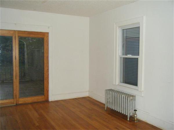 80 Norman Street Springfield, MA 01104 - Photo 8 of 16 an empty room with wooden floor and windows